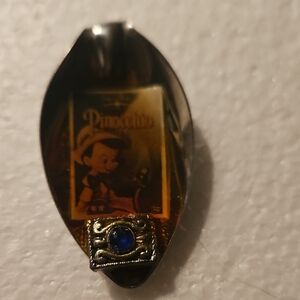 Pinocchio Vintage-Inspired Gold Tone Spoon Pendant with Blue Jewel